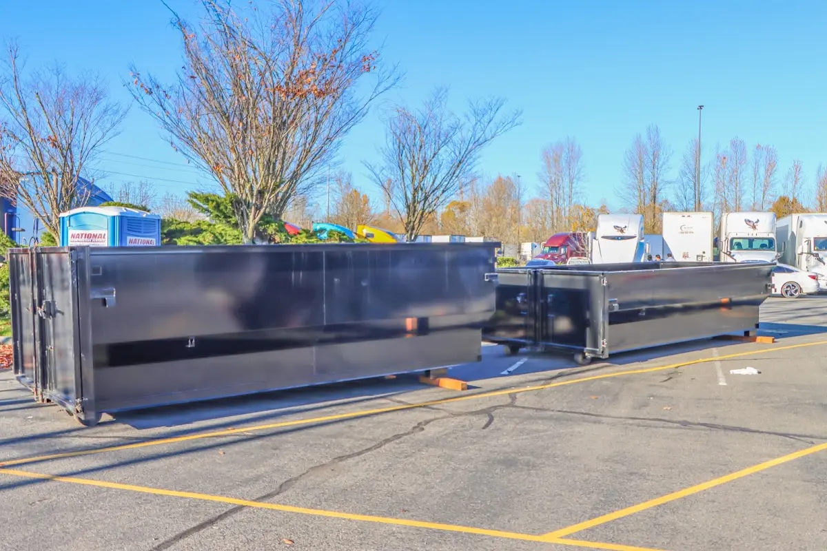 Professional dumpster rental service with roll-off container on residential driveway in Mantua